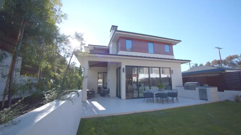 Covered loggia and lawn at The Linden Residence