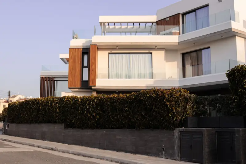 Modern home with teak screens and glass balconies in evening light